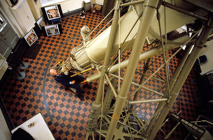 Patrick Moore sits at the 28-inch refracting telescope in the Royal Observatory in Greenwich in 1990