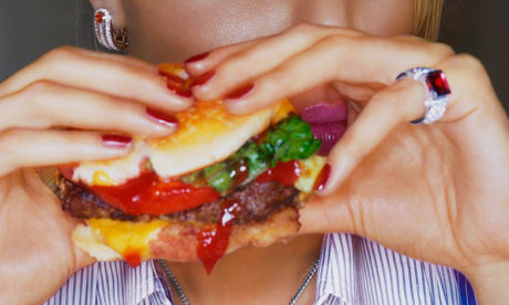 Woman eating a cheeseburger