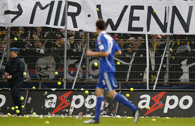 On pitch protests: FC Basel supporters throw tennis balls