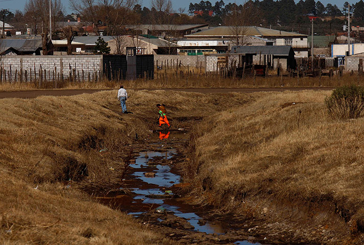 Drought in Mexico: Tarahumara Indians cross a dried creek in Guachochi