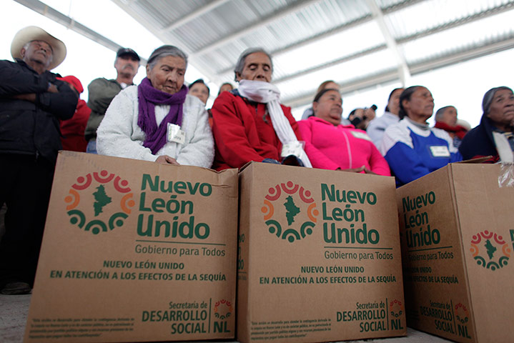 Drought in Mexico: Farmers sit with boxes of aid they received in the state of Nuevo Leon