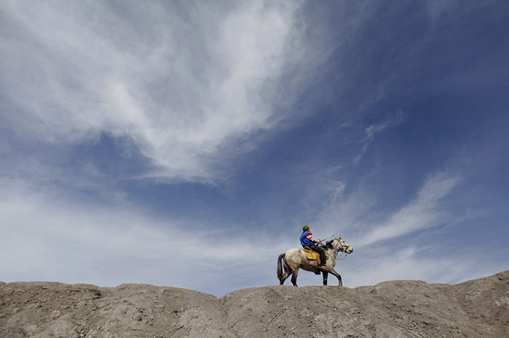 24 hours in pictures: A farmer rides his horsein Nuevo Leon
