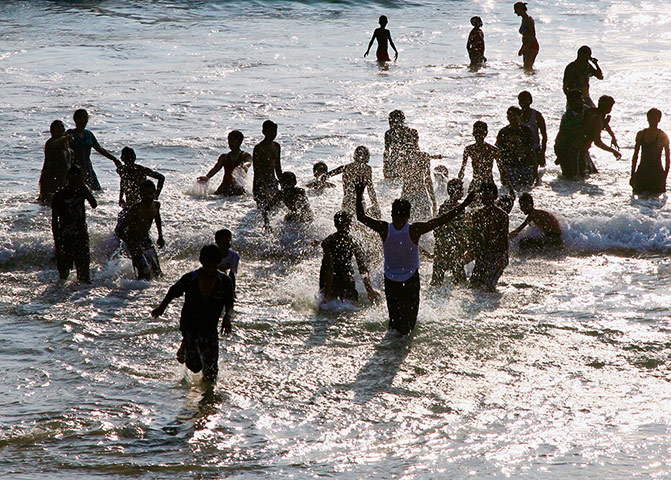 In pictures: splash: holidaymakers on Kovallam beach