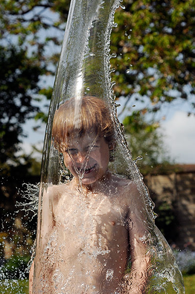 In pictures: splash: Water pouring on boy