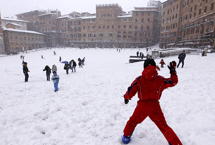 Cold snap continues: Children throw snowballs in Siena's Piazza del Campo, Italy 