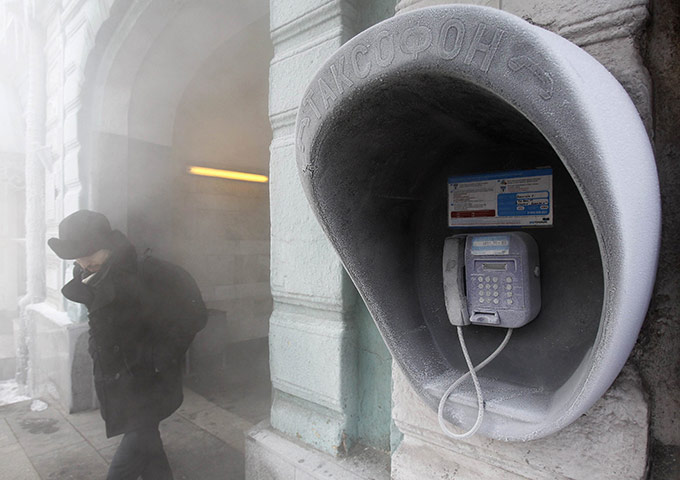 Cold snap continues: A man passes by a city phone, covered with hoarfrost, in Kiev