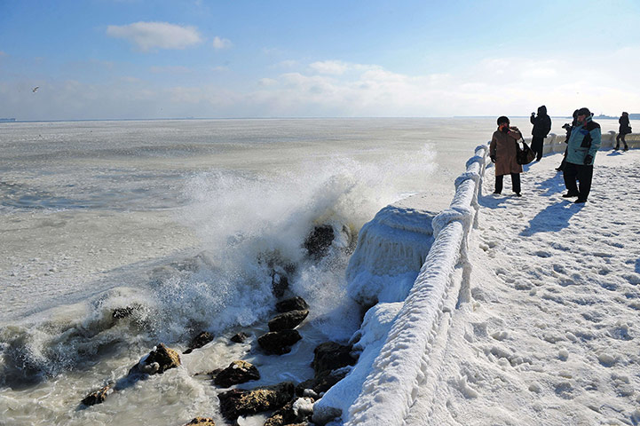 Cold snap continues: People photograph the frozen sea in Constanta, Romania