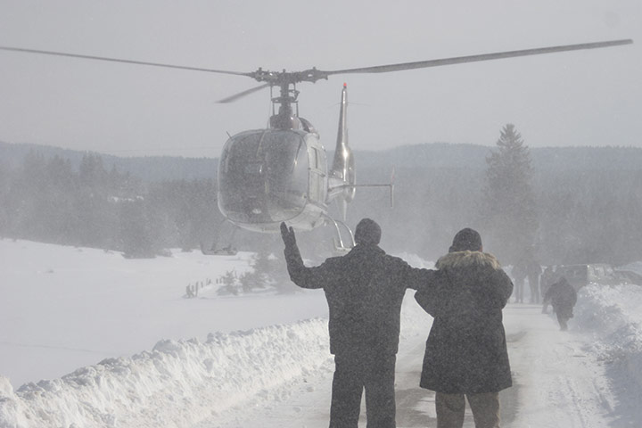 Cold snap continues: Bosnian people waving to helicopter crew as they wait for food supplies