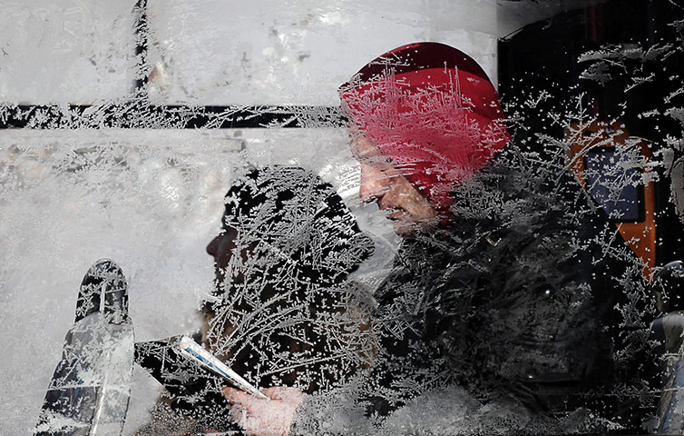 Cold snap continues: A man sits behind a frosty window on a tram in Sofia, Bulgaria
