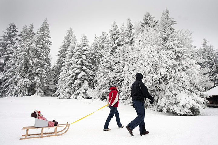 Cold snap continues: A family makes its way through a snowy winter landscape