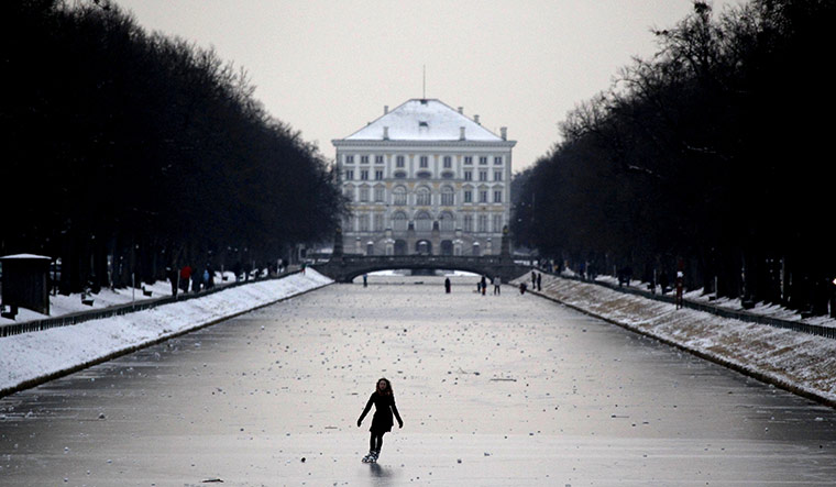 Cold snap continues: A young girl skates on the frozen canal of castle Nymphenburg in Munich