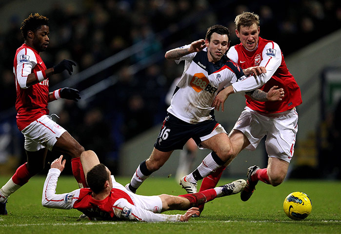 Premier League Wednesday: Arsenal's Thomas Vermaelen challenges Mark Davies of Bolton Wanderers 