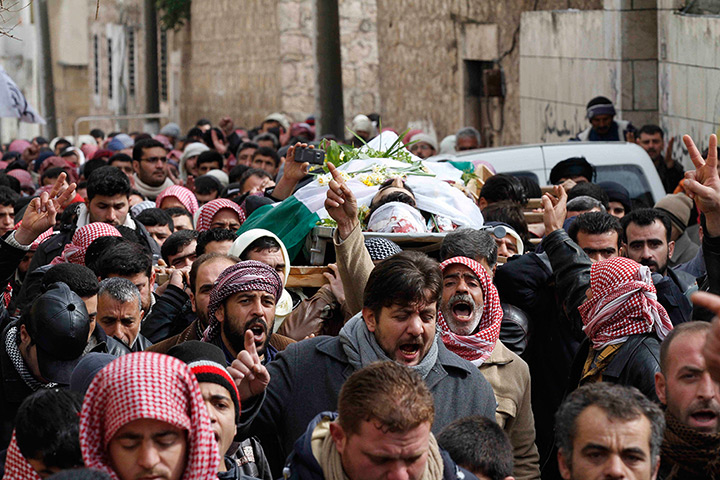 Syria: Mourners carry a body during a funeral