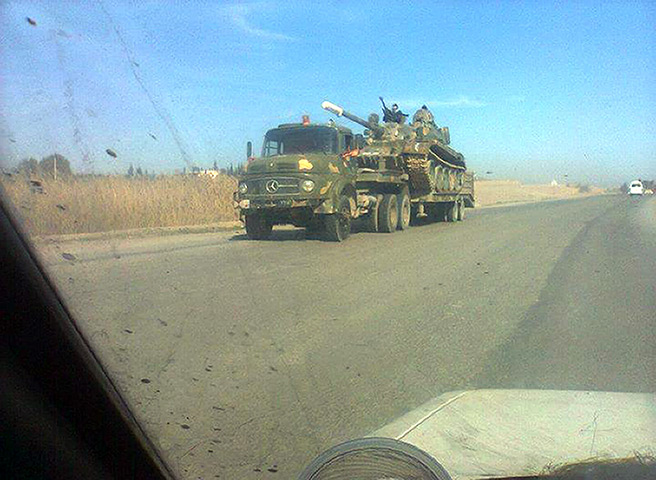 Syria: an army tank being transported on the Northern Road of 