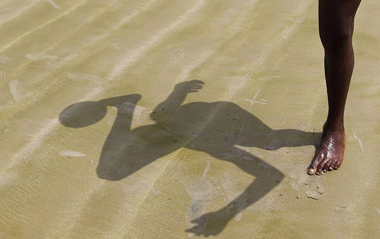 24 hours in pictures: A boy plays soccer on a beach in Libreville, Gabon