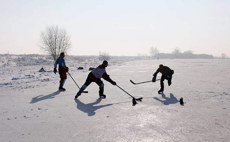 UK weather: A game of ice hockey on a frozen fen in Sutton