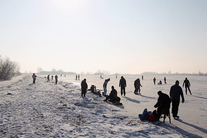 UK weather: Enthusiasts skate on a frozen fen in Sutton