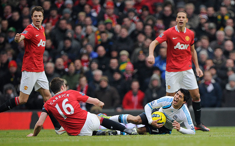 United v Liverpool: Luis Suarez is fouled by Michael Carrick