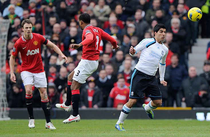 United v Liverpool: Luis Suarez clips the ball away from Patrice Evra