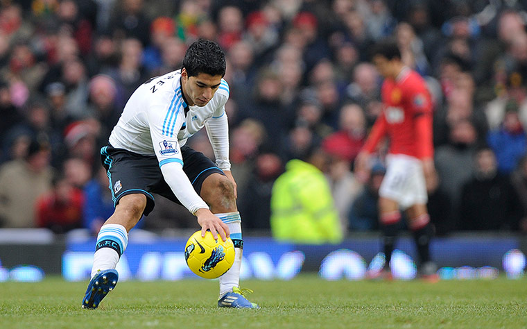 United v Liverpool: Luis Suarez puts the ball back on the centre circle after scoring