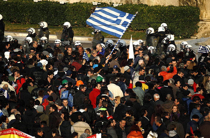 Athens demo: Anti-austerity protesters wave a Greek flag in Athens