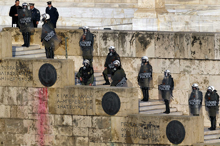 Athens demo: Police in riot gear stand guard outside the parliament 