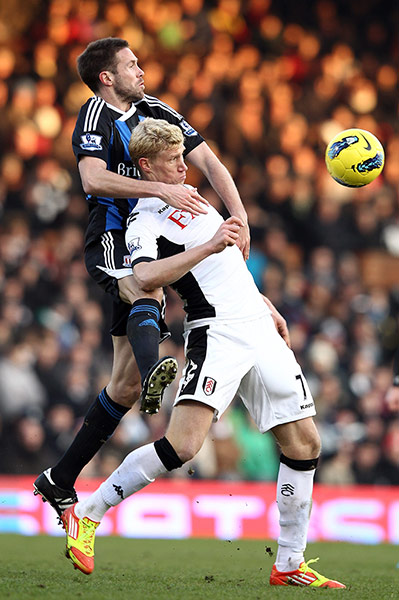 Prem round up: Matthew Upson of Stoke City challenges Pavel Pogrebnyak of Fulham 