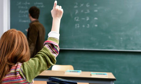 girl raising hand in classroom
