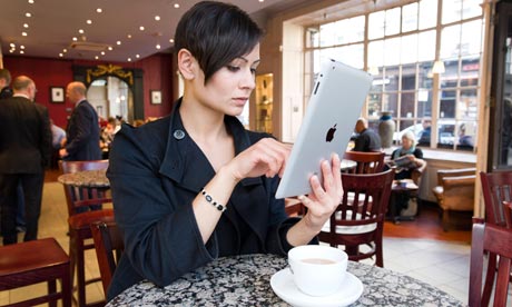Young woman browsing the Internet on an Apple iPad 2 tablet