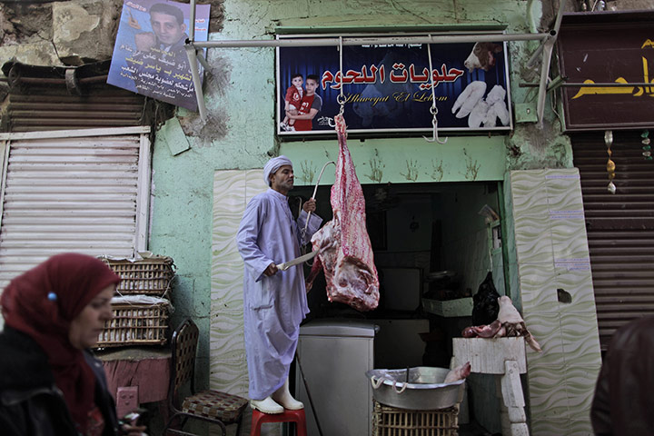 24 hours in pictures: An Egyptian butcher cuts meat in a market in Cairo, Egypt