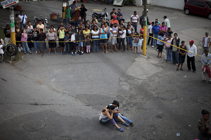 24 hours in pictures: Relatives mourn the death of a relative shot to death in Guatamala