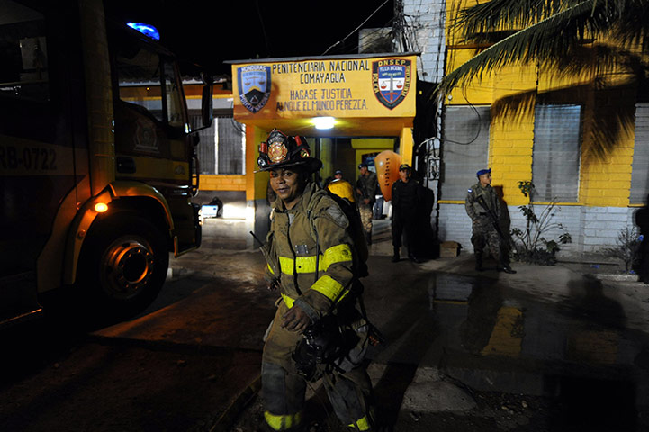 Honduras prison fire: Firemen enter the National Prison of Comayagua where a fire broke out
