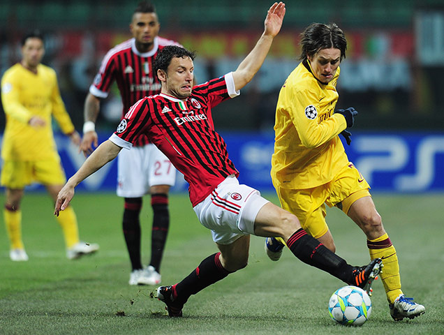 Champions League Wed: Mark van Bommel of AC Milan challenges Tomas Rosicky of Arsenal