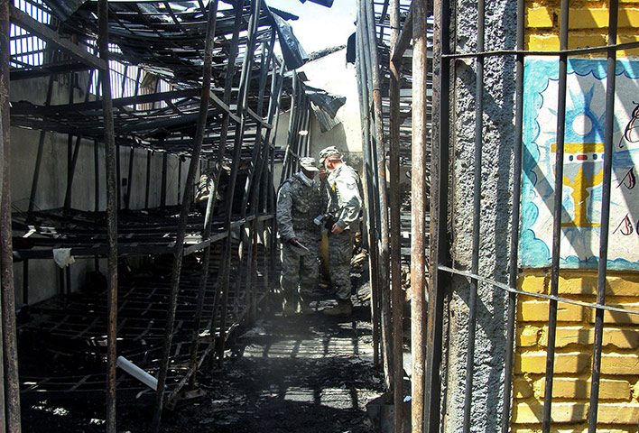 Honduras jail: Soldiers inspect  the burnt National Prison compound