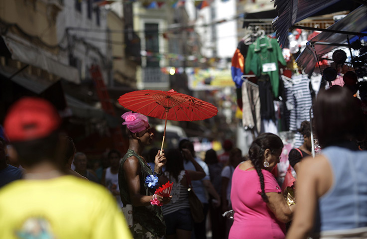 24 hours: Rio de Janeiro, Brazil: A salesman wearing a carnival costume