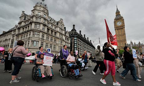 Disabled protestors demonstrate past the