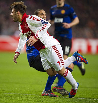 Ajax v United: Miralem Sulejmani goes down in the area after a challenge by Rio Ferdinand