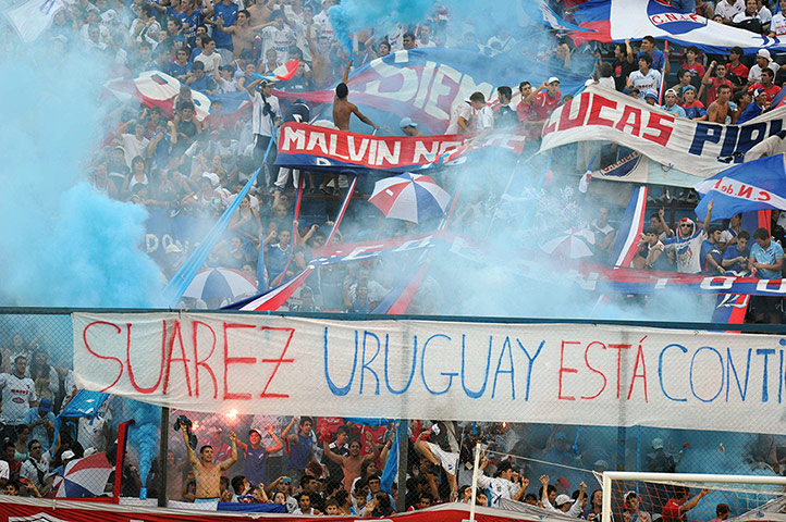 Best of the week: Uruguayan Nacional's fans cheer and show banners in support of Luis Suarez 