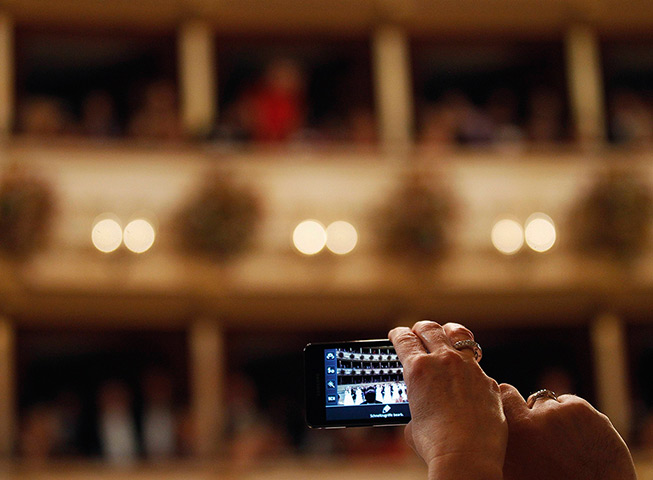 Vienna Opera Ball: A guest takes a photo inside the Vienna State Opera House