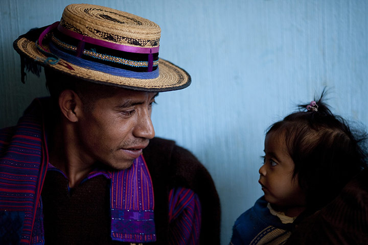 24 hours: San Juan Atitan, Guatemala: A man speaks with a girl who will be weighed