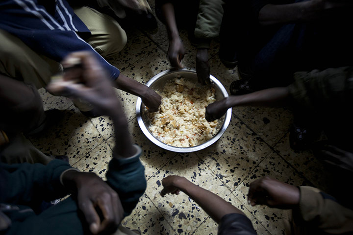 24 hours: Tel Aviv, Israel: African refugees share breakfast at a shelter