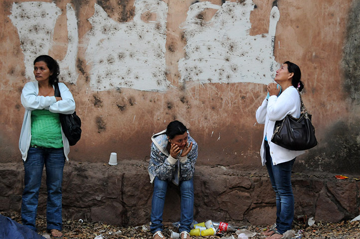 24 hours: Tegucigalpa, Honduras: Women wait to recover the remains of their relatives