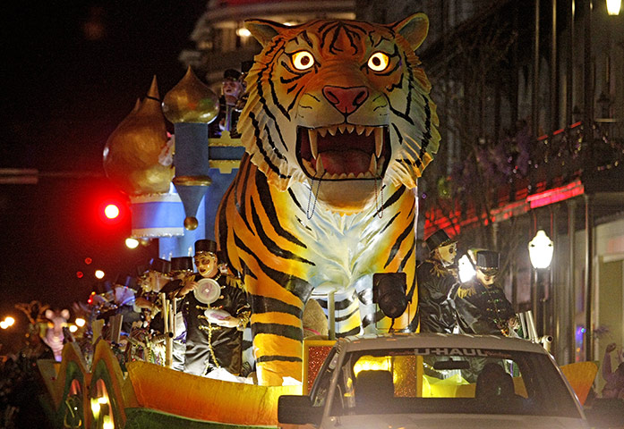 24 hours: Alabama, US: Revelers with the Mystic Stripers toss trinkets to the crowd