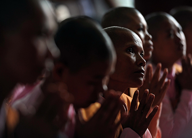 24 hours: Rangoon, Burma: Buddhist nuns pray during a farewell ceremony for Thiha