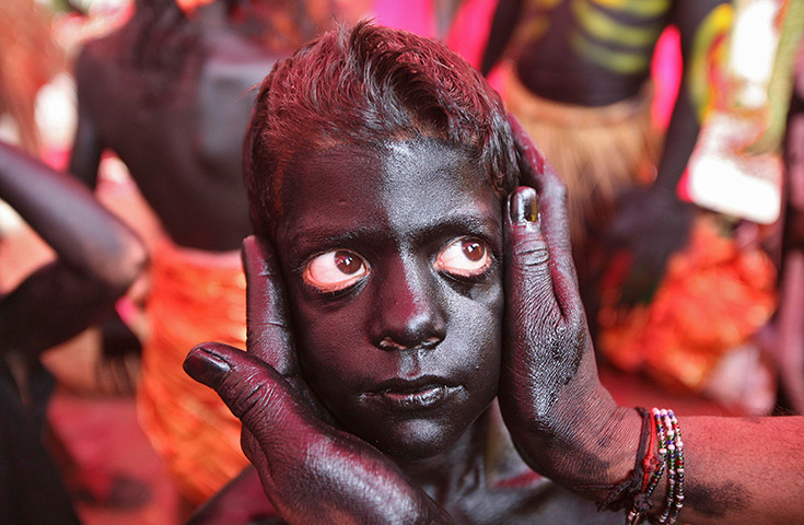 24 hours: Jammu, India: A boy is made up to look like a demon