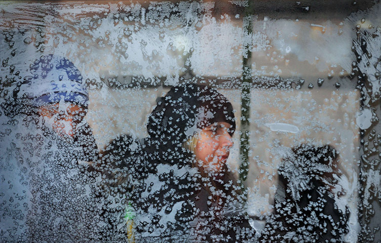 24 hours in pictures: Sofia, Bulgaria: People are seen through an icy window on a tram