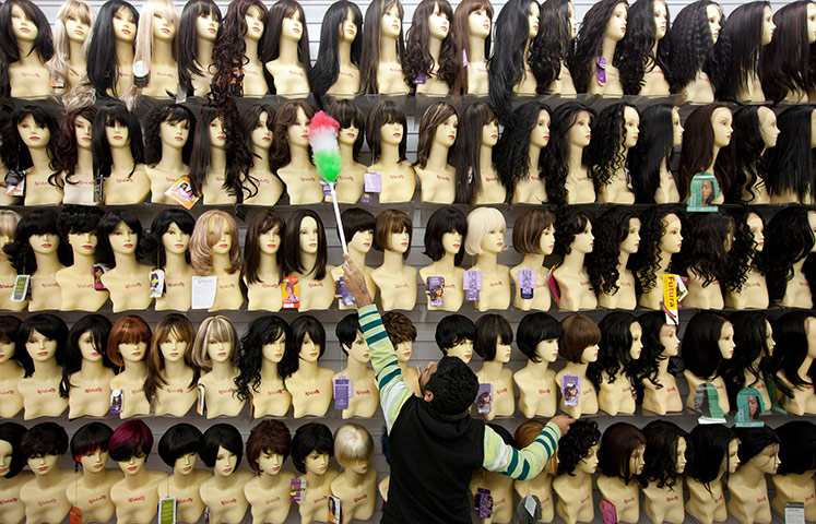24 hours in pictures: London, UK: A man dusts shop mannequins