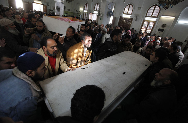 Port Said clashes: Mourners carry the bodies of victims of soccer violence in Port Said
