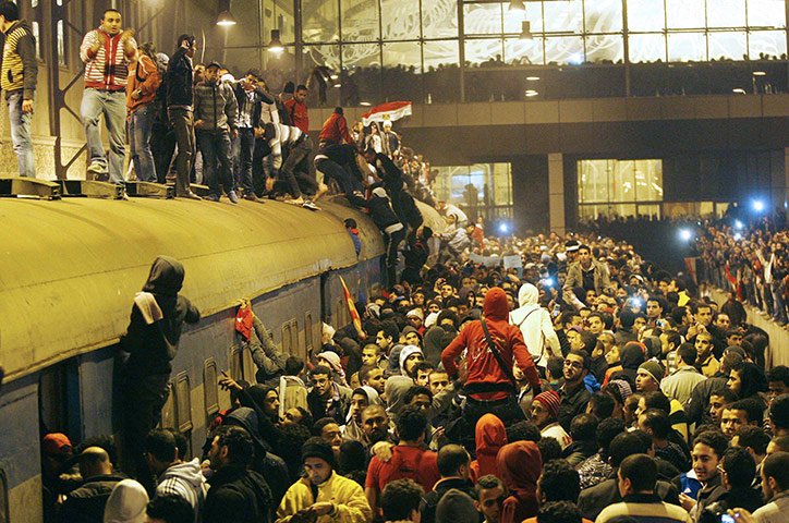 Port Said clashes: People on a train wait for those wounded during clashes in Port Said 