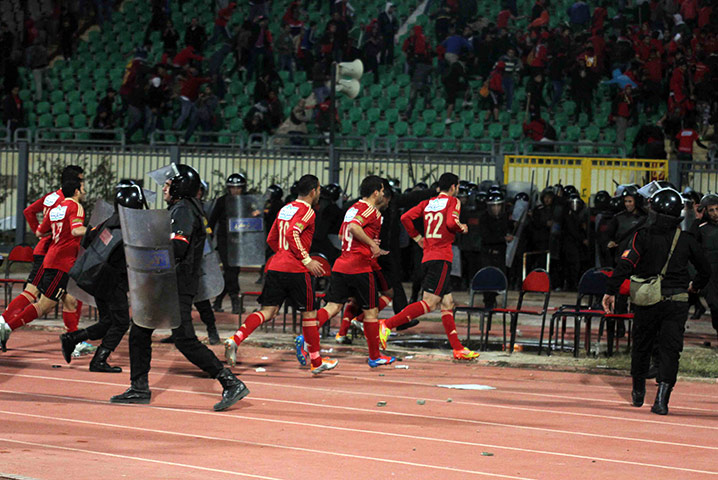 Port Said clashes: El-Ahly football players leave the the pitch at the Port Said stadium